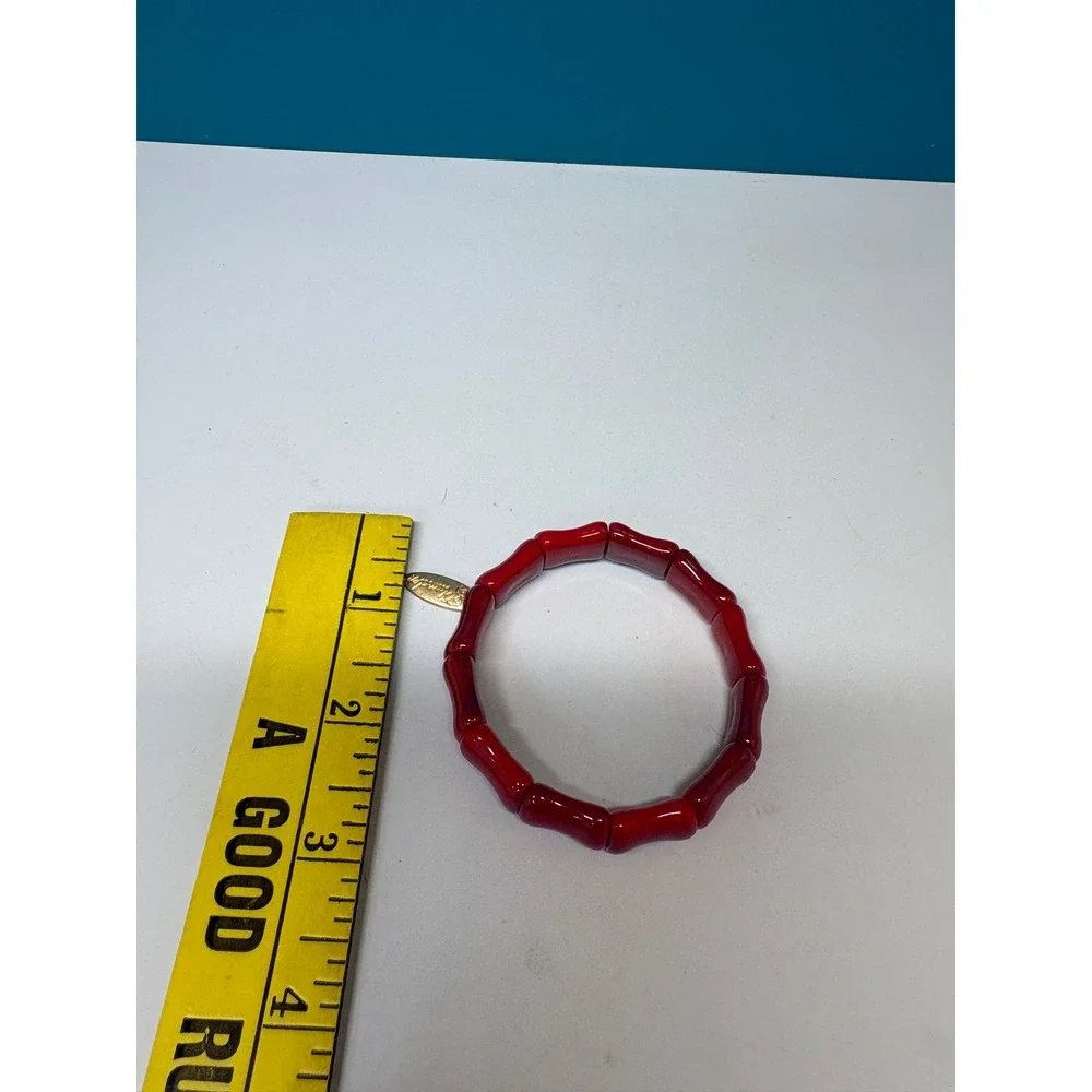 Plunder Design Red Bamboo Style Stretch Bracelet Gold Tone Logo Charm